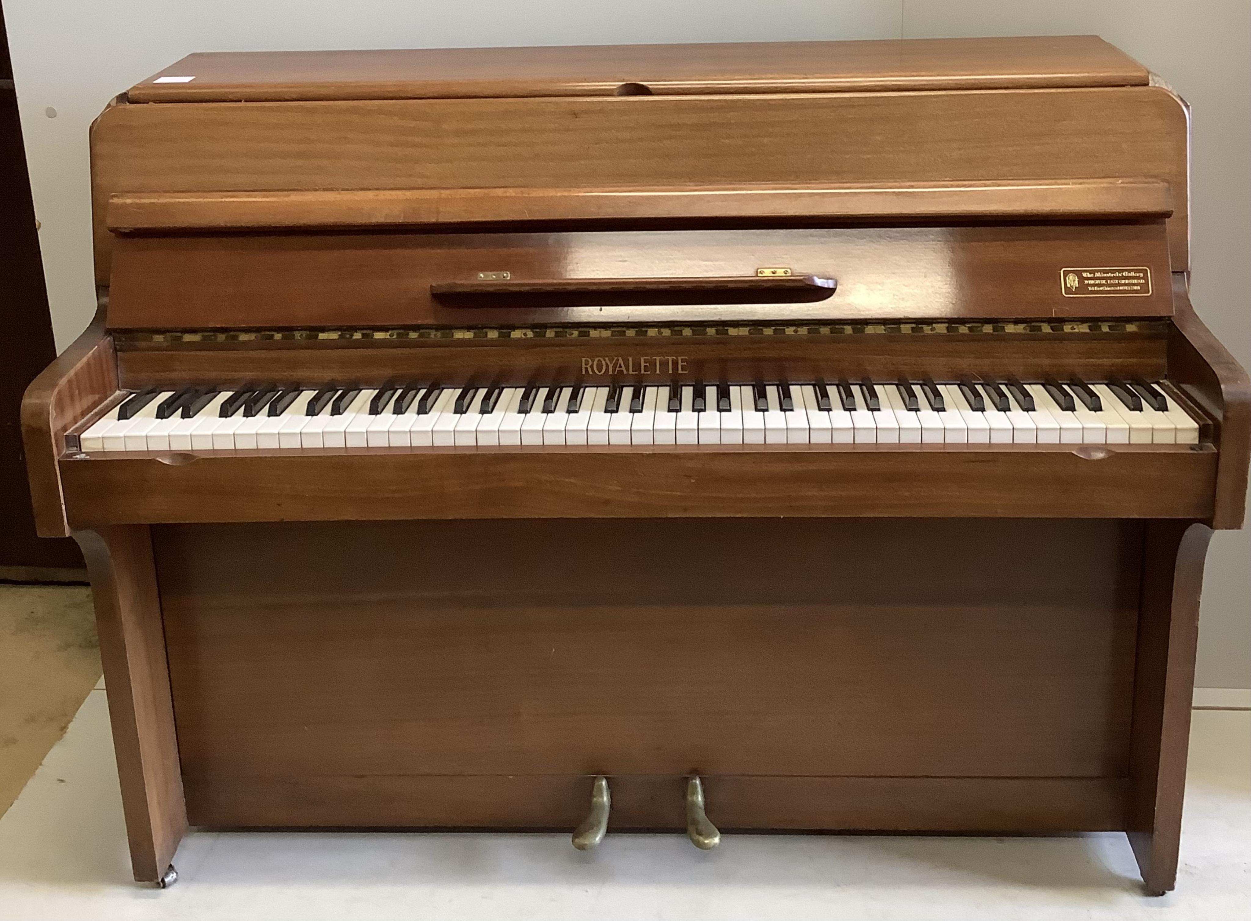 A 1960’s Royalette mahogany cased mini piano, with seven octaves, width 128cm, height 100cm. Condition - fair, one piece of timber detached but present